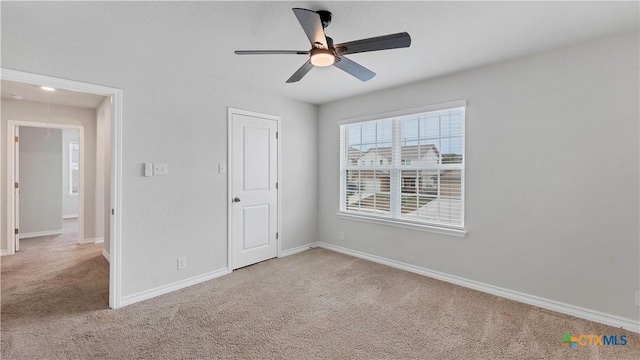 unfurnished bedroom with ceiling fan and carpet floors