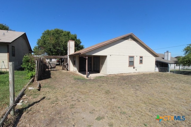 rear view of property featuring a yard