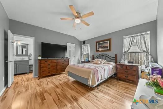 2303 Schwald Rd, Killeen, TX 76543 - bedroom featuring light wood-type flooring, lofted ceiling, connected bathroom, and a ceiling fan