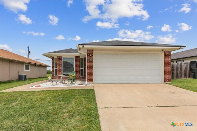 2303 Schwald Rd, Killeen, TX 76543 - view of front facade with brick siding, cooling unit, concrete driveway, and an attached garage