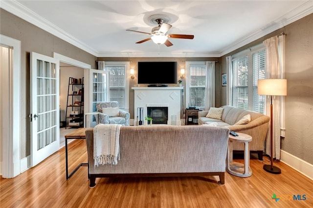 406 S Liberty St, Victoria, TX 77901 - living area with light wood-style flooring, ornamental molding, a fireplace, and a ceiling fan