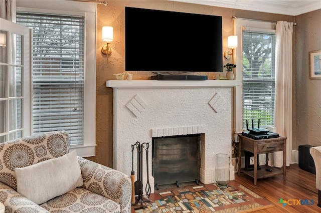406 S Liberty St, Victoria, TX 77901 - living room featuring a textured wall, a wealth of natural light, a fireplace, and wood finished floors