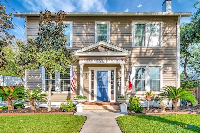 406 S Liberty St, Victoria, TX 77901 - colonial home with a front yard and a chimney
