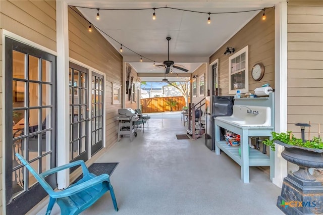 406 S Liberty St, Victoria, TX 77901 - view of patio / terrace featuring french doors, a sink, fence, and a ceiling fan