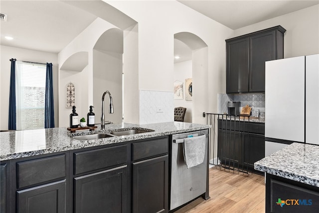 5712 Red Fish Ct, Belton, TX 76513 - kitchen featuring a sink, dishwasher, light stone countertops, and decorative backsplash