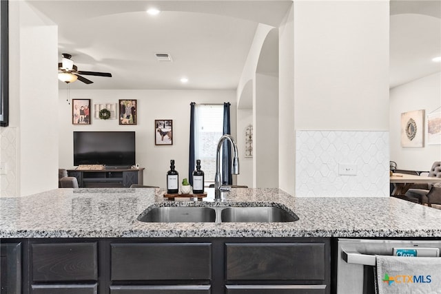 5712 Red Fish Ct, Belton, TX 76513 - kitchen featuring a sink, open floor plan, stainless steel dishwasher, dark cabinets, and a ceiling fan