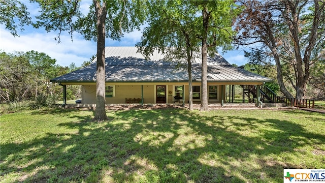 rear view of house with a yard