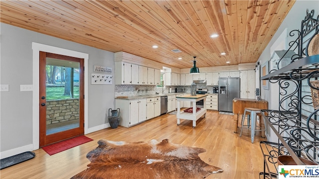 kitchen featuring white cabinetry, appliances with stainless steel finishes, wood ceiling, light hardwood / wood-style floors, and a center island