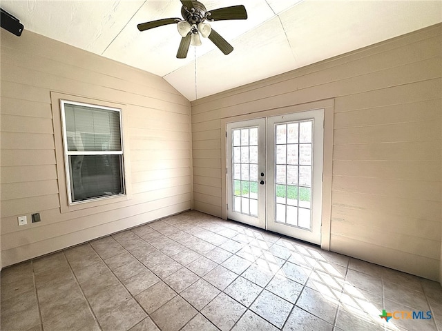 214 Yellowstone Dr, Victoria, TX 77904 - empty room with french doors, wood walls, vaulted ceiling, and a ceiling fan