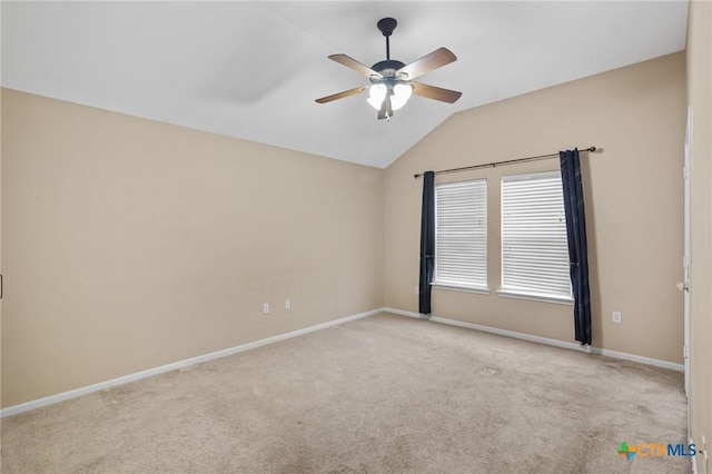 unfurnished room with baseboards, vaulted ceiling, a ceiling fan, and light colored carpet