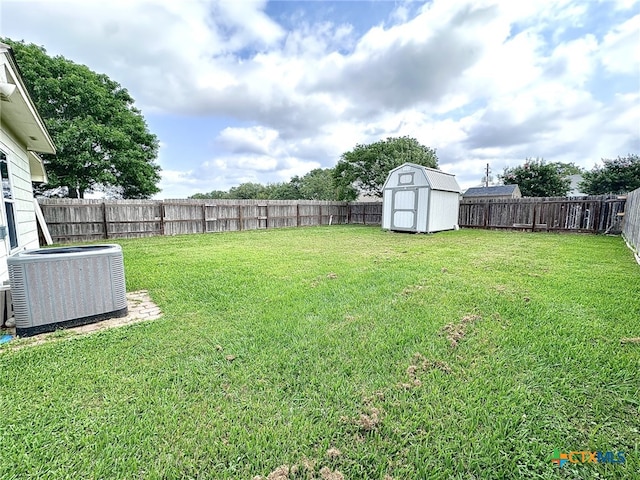 214 Yellowstone Dr, Victoria, TX 77904 - view of yard featuring central air condition unit, a storage shed, and an outbuilding