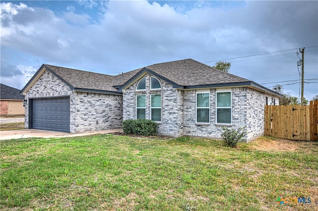 view of front of home featuring a garage and a front yard