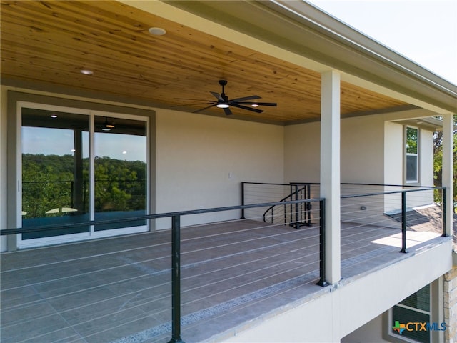 wooden deck featuring ceiling fan