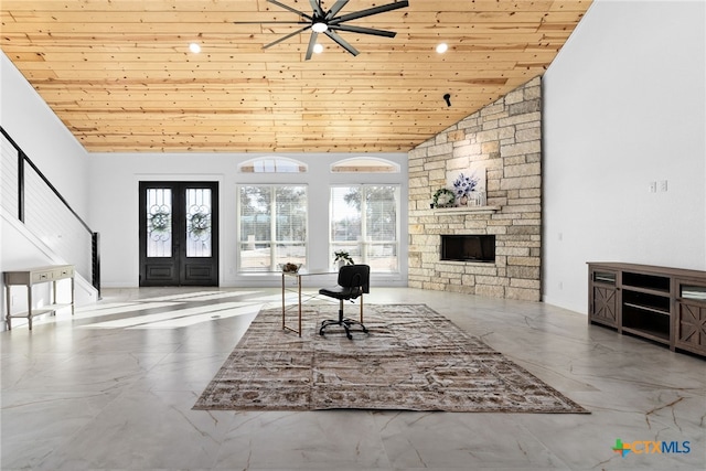 living room featuring high vaulted ceiling, wooden ceiling, a stone fireplace, and french doors