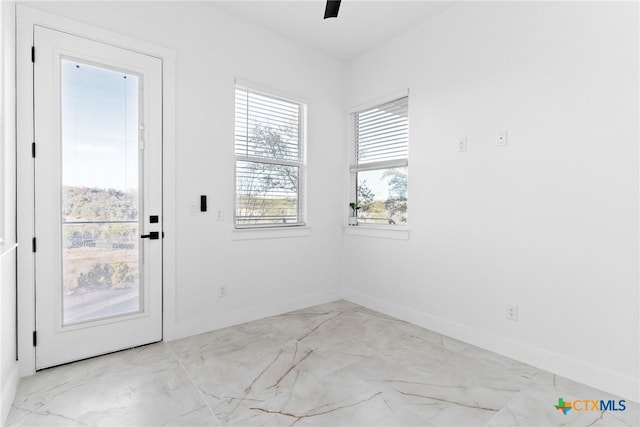 doorway with ceiling fan