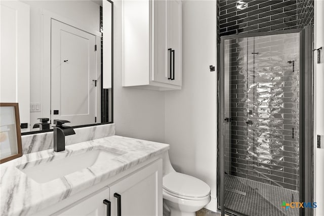 bathroom with vanity, toilet, and an enclosed shower