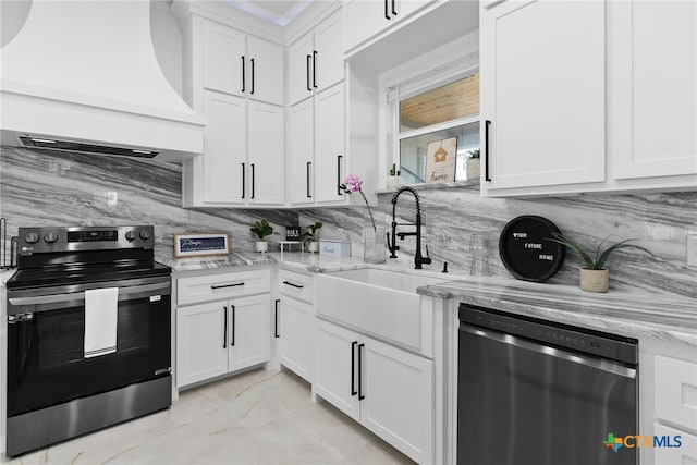 kitchen with white cabinetry, stainless steel appliances, custom exhaust hood, and sink