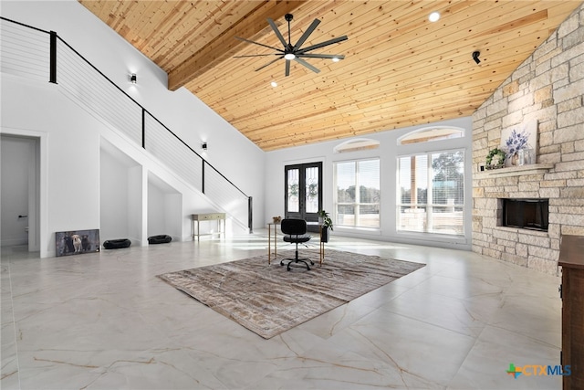 living room featuring beamed ceiling, a stone fireplace, wooden ceiling, high vaulted ceiling, and ceiling fan