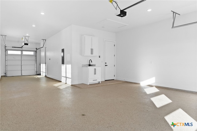 garage featuring sink and a garage door opener