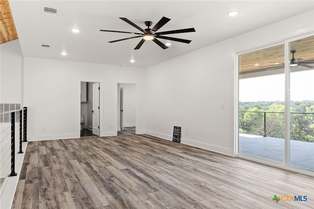 unfurnished living room featuring ceiling fan and light wood-type flooring