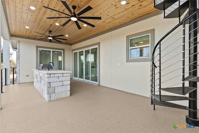 view of patio / terrace with ceiling fan and a wet bar