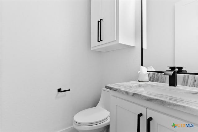 bathroom featuring toilet and vanity