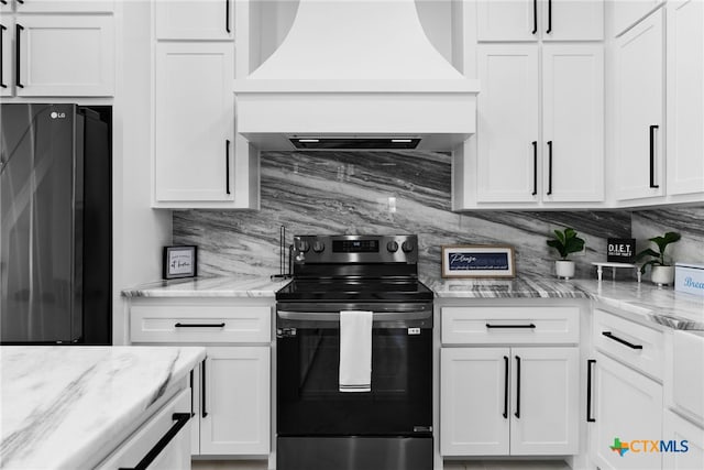 kitchen with refrigerator, white cabinetry, custom range hood, electric range, and backsplash