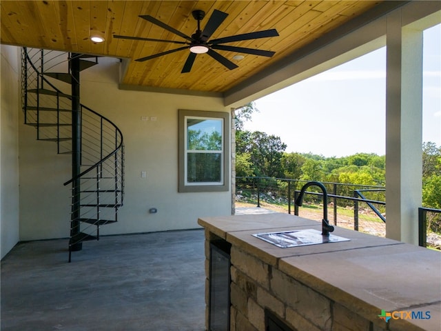 view of patio / terrace with ceiling fan and exterior bar