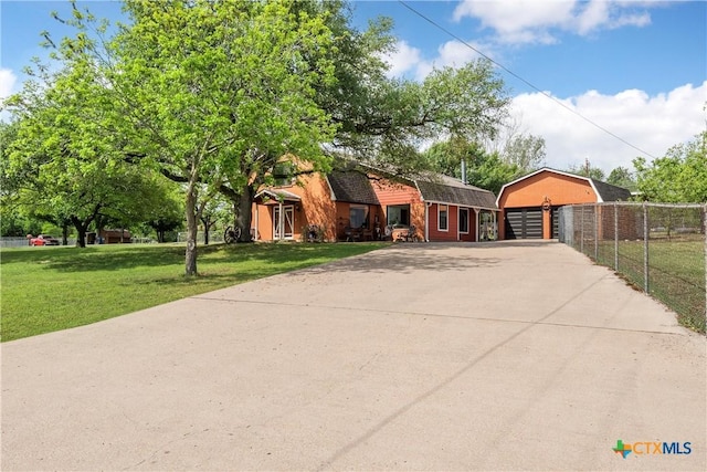 view of front of house with fence, a front yard, and a garage