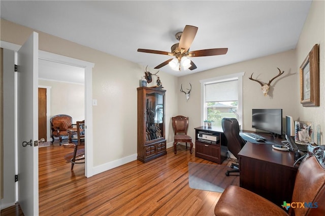 office with light wood-type flooring, a ceiling fan, and baseboards