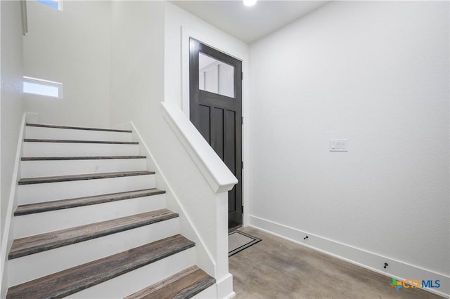 staircase with baseboards and carpet flooring