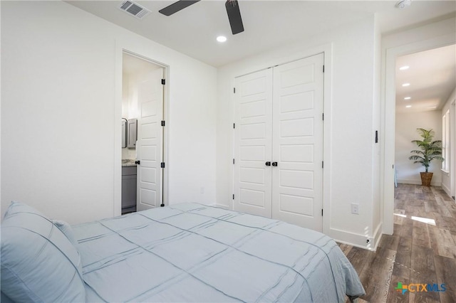 bedroom with dark wood finished floors, recessed lighting, a closet, visible vents, and baseboards