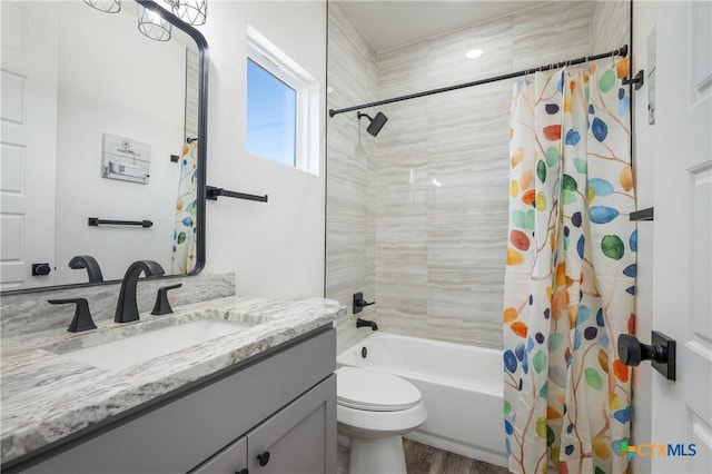 full bathroom with toilet, shower / tub combo with curtain, and vanity