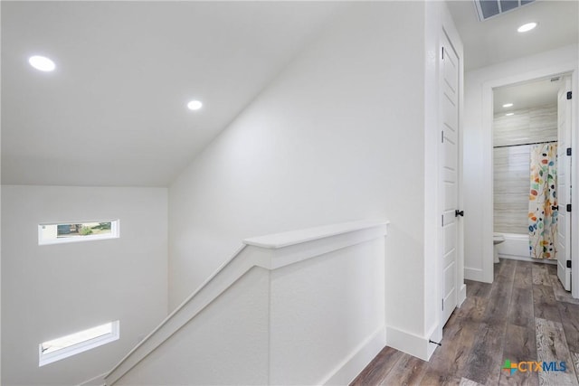 hall with recessed lighting, visible vents, baseboards, an upstairs landing, and dark wood finished floors