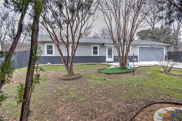 ranch-style home with a garage and a front lawn