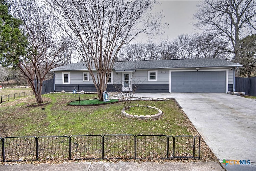 ranch-style house with a garage and a front yard