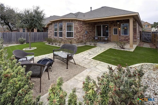 back of property featuring an outdoor living space, a patio, and a yard