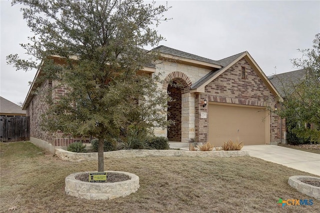 view of front of home with a garage and a front lawn