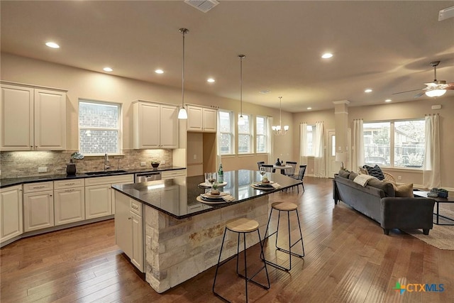 kitchen featuring white cabinetry, a breakfast bar, and a center island