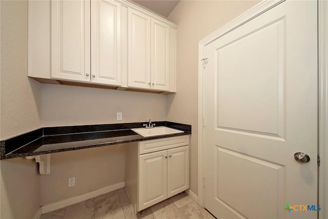 clothes washing area with sink