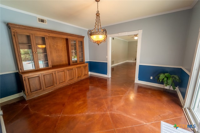 unfurnished dining area with ceiling fan and crown molding