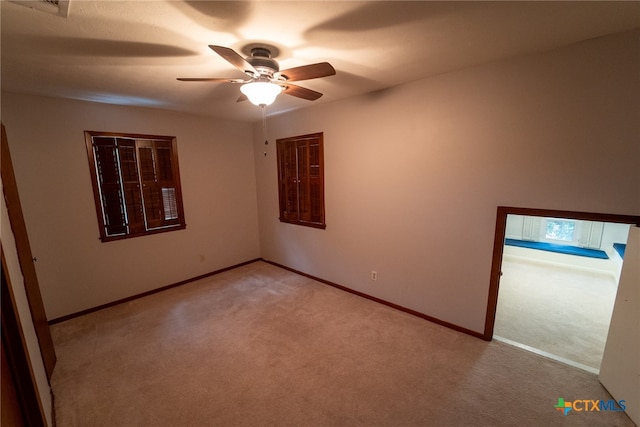 carpeted empty room with ceiling fan