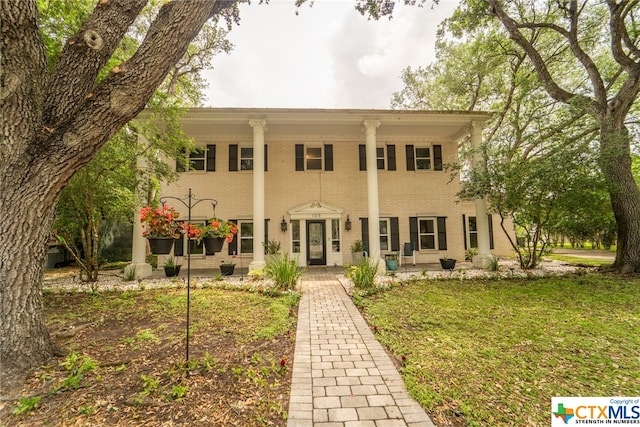 view of front of house featuring french doors and a front lawn