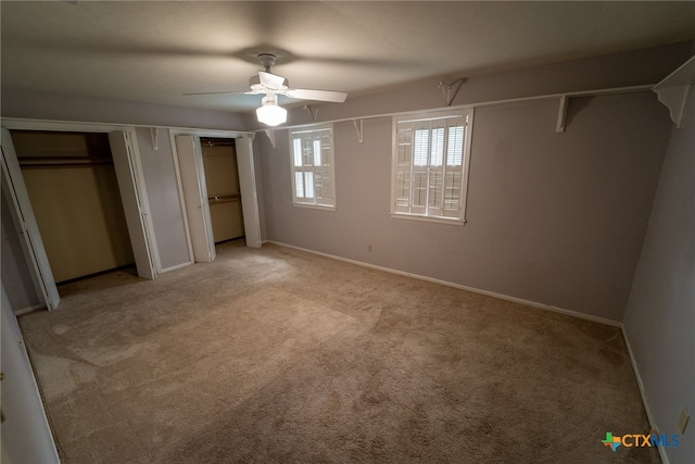 unfurnished bedroom featuring light colored carpet and ceiling fan