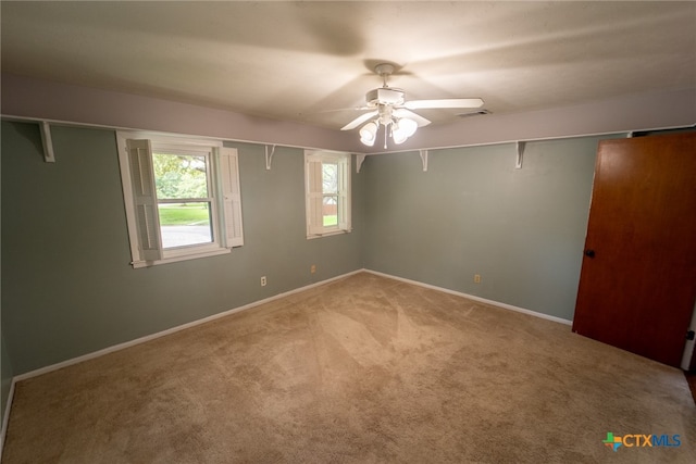 spare room featuring carpet flooring and ceiling fan