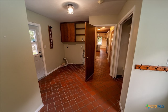 hallway with dark tile patterned flooring