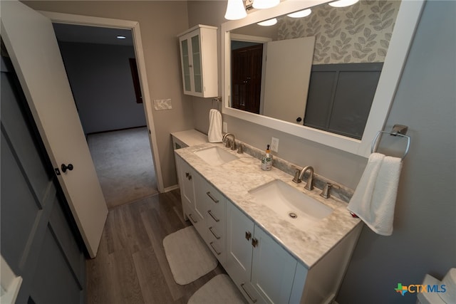 bathroom with hardwood / wood-style floors and vanity