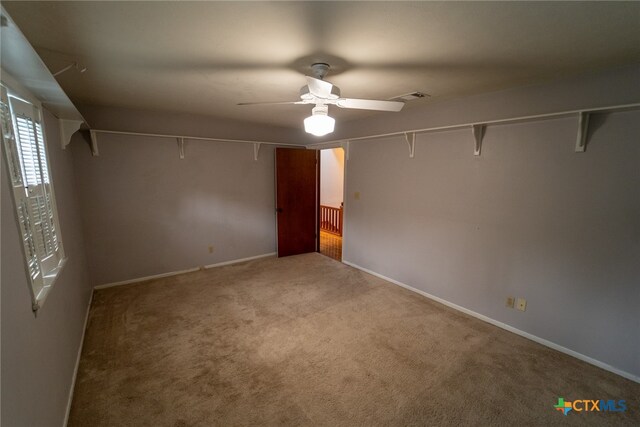 spare room featuring carpet and ceiling fan