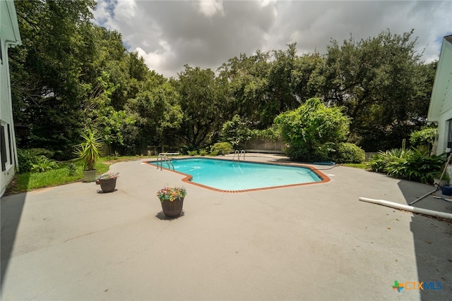 view of swimming pool featuring a patio area