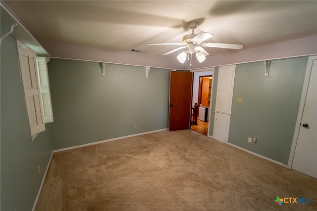 unfurnished bedroom with a closet, light carpet, and ceiling fan